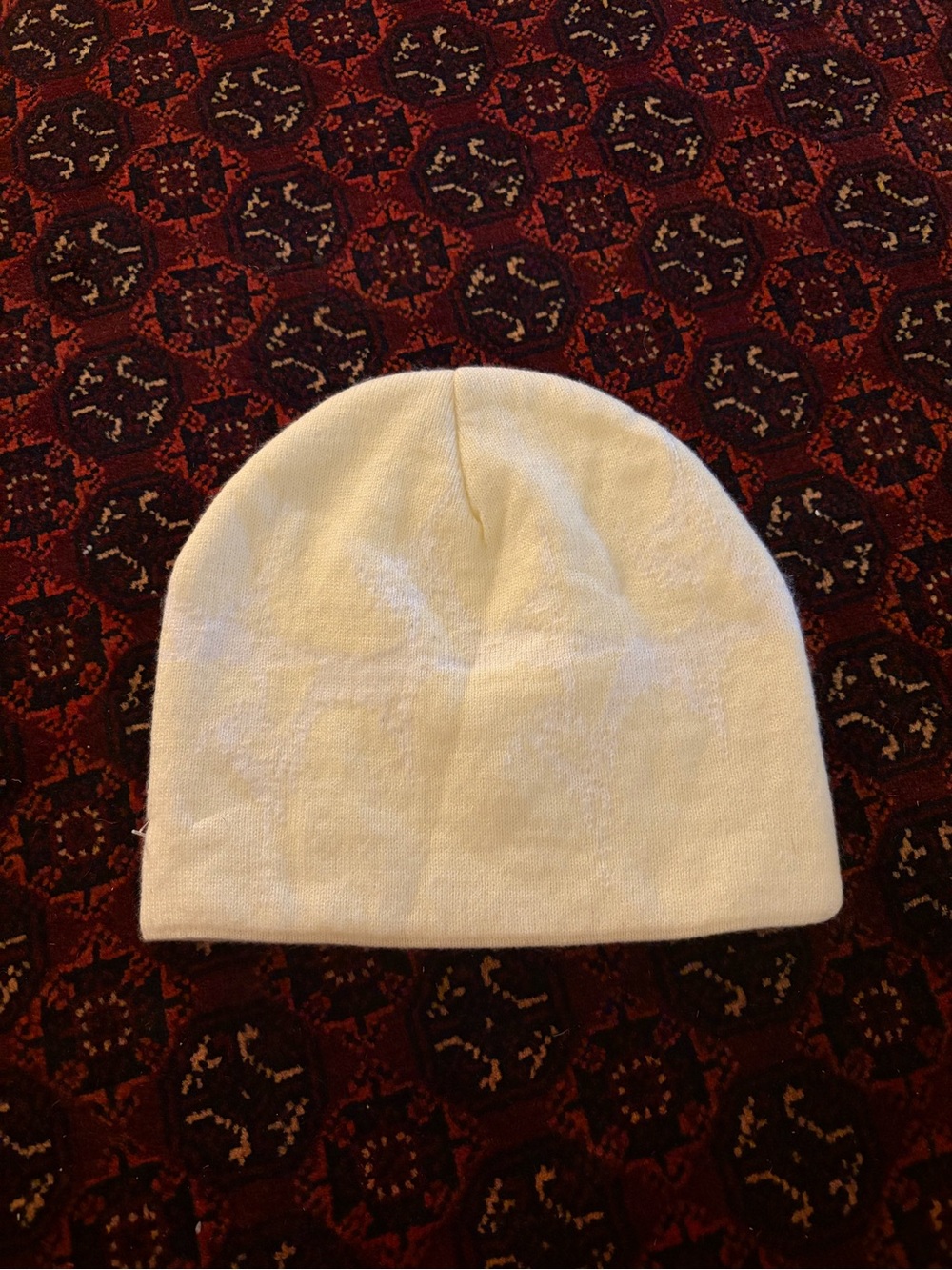GB Mouth cream and white colored beanie